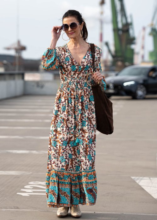 Sukienka maxi w stylu boho z etniczno-kwiatowym printem w odcieniach turkusu, beżu i brązu. Model z głębokim dekoltem V, elastycznym pasem oraz zwiewnymi rękawami pięknie podkreśla sylwetkę