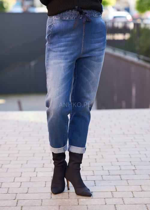 Niebieskie jeansowe spodnie damskie z mankietami i gumką w pasie, casualowy fason z wiązaniem