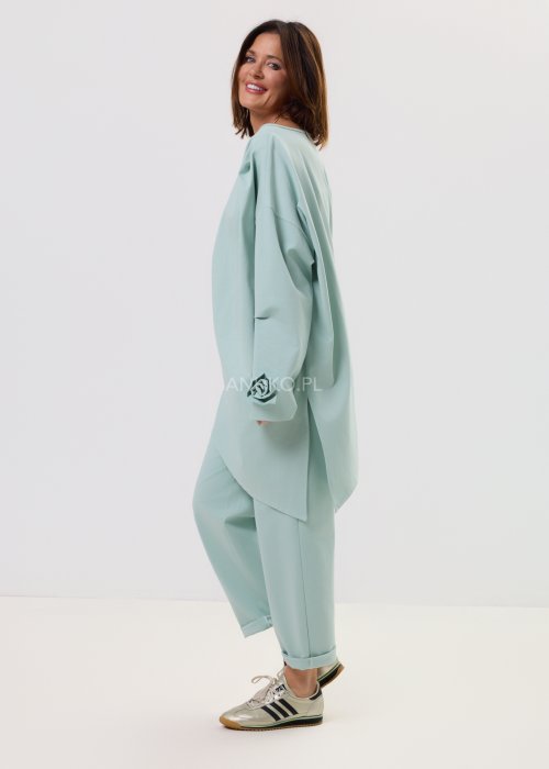 Damska miętowa bluzka Starola Rose o luźnym, oversize’owym kroju z asymetrycznym dołem i szerokim rękawem, w eleganckiej stylizacji total look.