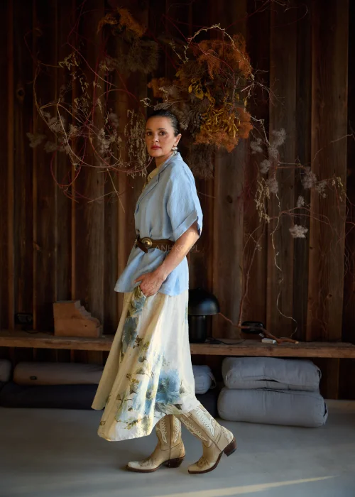 Lniana marynarka damska w kolorze baby blue o luźnym kroju, z krótkim rękawem i klasycznym kołnierzem, stylizacja warstwowa w naturalnym, eleganckim klimacie.