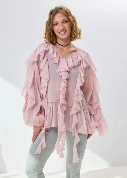 Pudroworóżowa bluzka damska z falbanami i luźnym fasonem boho. Zwiewny model z szerokimi rękawami i romantycznym wykończeniem przyciąga uwagę efektownymi detalami.