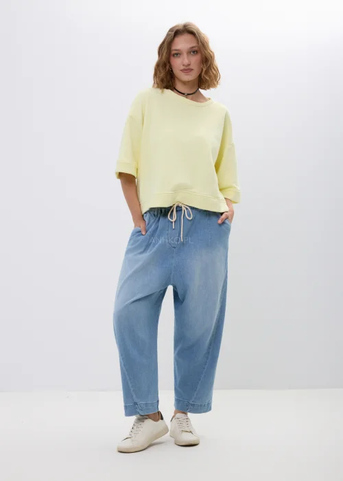 Żółta bluza oversize z krótkim rękawem i ściągaczem u dołu. Luźny fason w pastelowym odcieniu, idealny na co dzień.