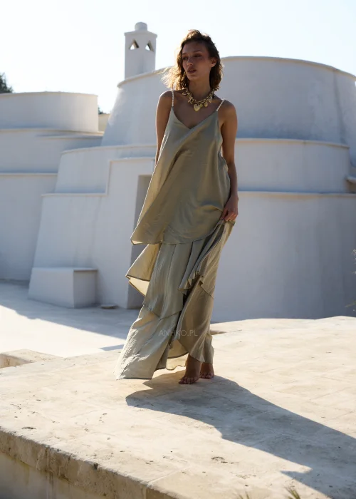 Oliwkowa sukienka maxi na cienkich ramiączkach z warstwowymi falbanami i luźnym, zwiewnym fasonem. Kobiecy model w stylu boho, idealny na wakacyjne stylizacje, spacery i letnie przyjęcia.