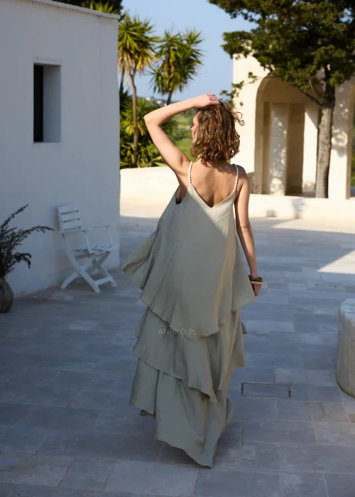Oliwkowa sukienka maxi na cienkich ramiączkach z warstwowymi falbanami i luźnym, zwiewnym fasonem. Kobiecy model w stylu boho, idealny na wakacyjne stylizacje, spacery i letnie przyjęcia.