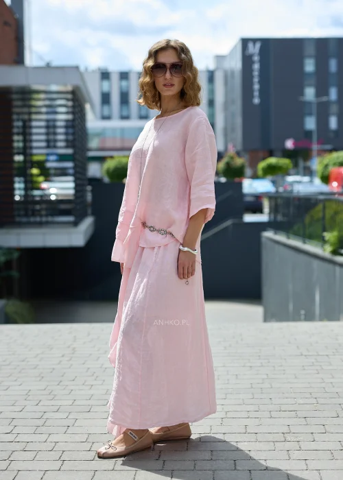 Pudroworóżowa lniana bluzka damska z rękawem 3/4, asymetrycznymi falbanami i luźnym fasonem oversize, prezentowana w eleganckiej miejskiej stylizacji.