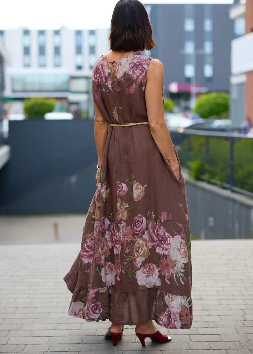 Lniana sukienka maxi w brązowym kolorze z dużym kwiatowym printem w odcieniach różu i beżu. Luźny fason z okrągłym dekoltem oraz plecionym paskiem w talii tworzy kobiecą stylizację w romantycznym stylu.